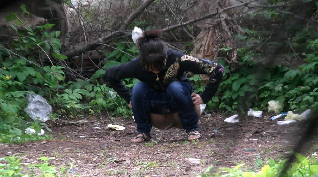 Girl peeing in bush